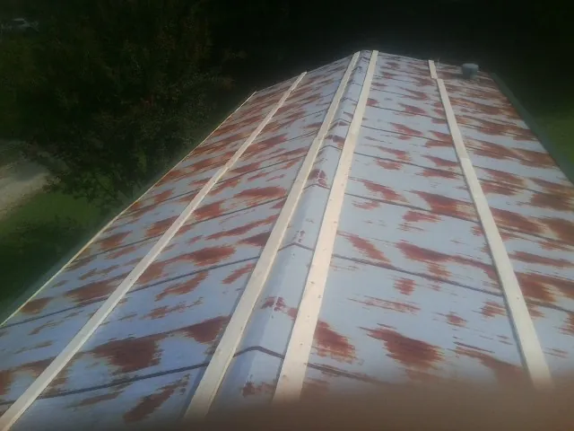 Rusted metal roof panels with new wood purlins before replacement — Storm Damage Roof Repair in Guys Mills by Roofing Brothers